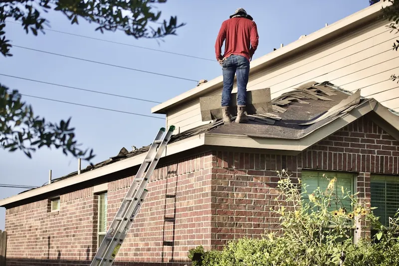 Professional roofer working on a residential roof in Fox Ridge